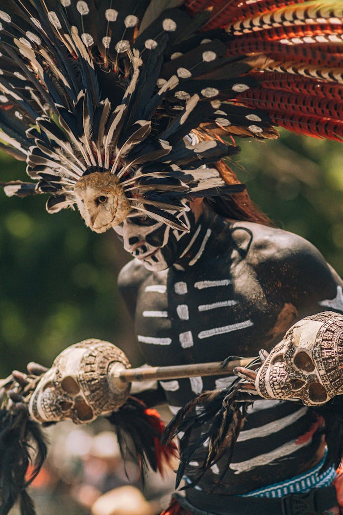 Colorful portrait of an Aztec warrior in traditional attire during a festival in Mexico.